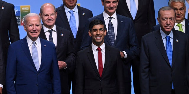 Biden and Sunak stand next to each other at NATO summit photo opp