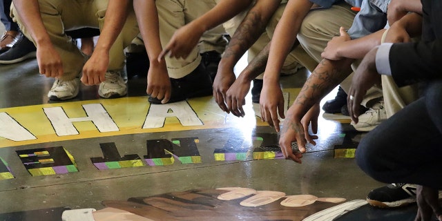 Incarcerated young adults pose for a group photo