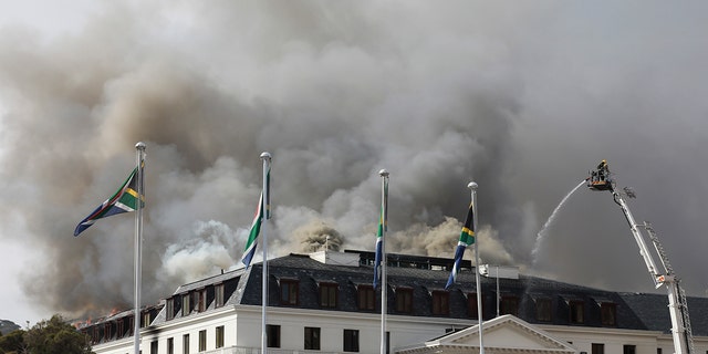 Smoke rises from the Parliament in Cape Town, South Africa