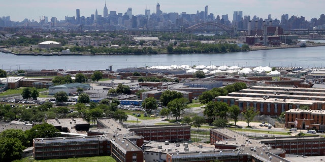 Rikers Island jail complex with NYC skyline