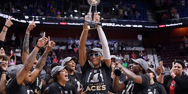 Aja Wilson holds up trophy