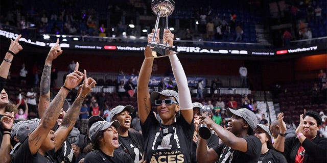 Aja Wilson holds up trophy