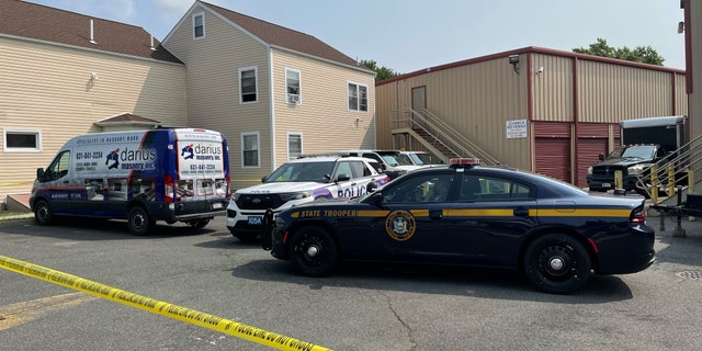 Police cars parked outside storage unit in Amityville, NY
