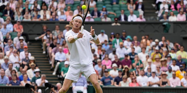 Andrey Rublev holds his racket