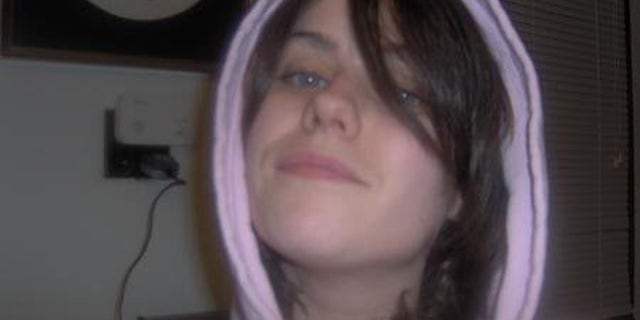 Maureen Brainard-Barnes smiles with her hood up wearing a pink sweatshirt