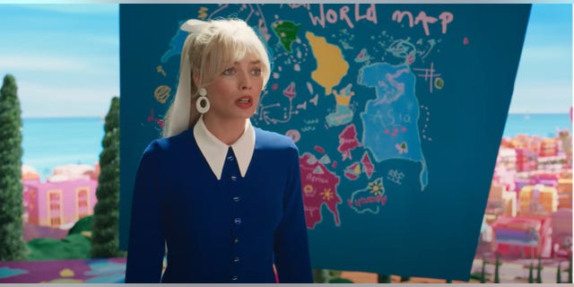 Margot Robbie in front of the cartoon map showing the nine dash line