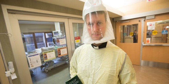 Priest in full PPE