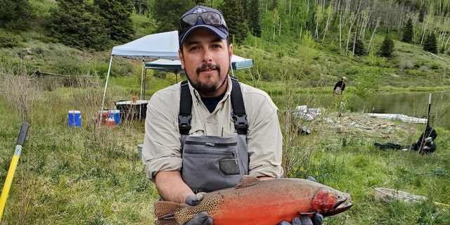 Estevan Vigil holds Rio Grande cutthroat trout