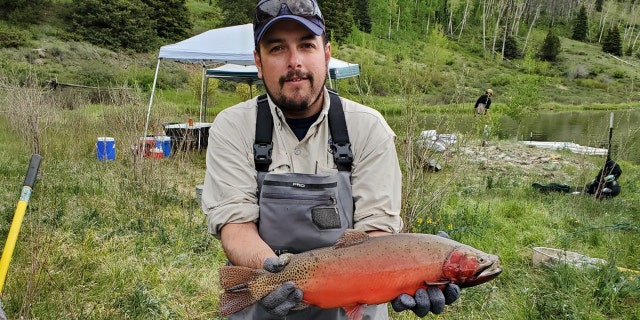 Estevan Vigil holds Rio Grande cutthroat trout