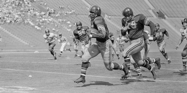 C.R. Roberts runs with football