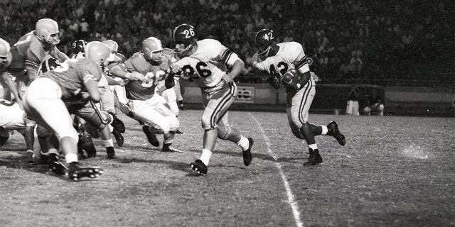 C.R. Roberts running with football