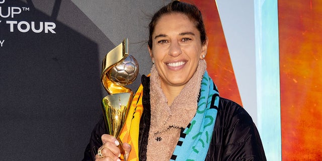 Carli Lloyd poses with the World Cup trophy.