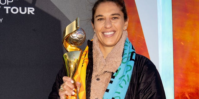 Carli Lloyd poses with World Cup trophy