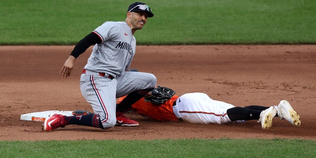 Carlos Correa marks the runner