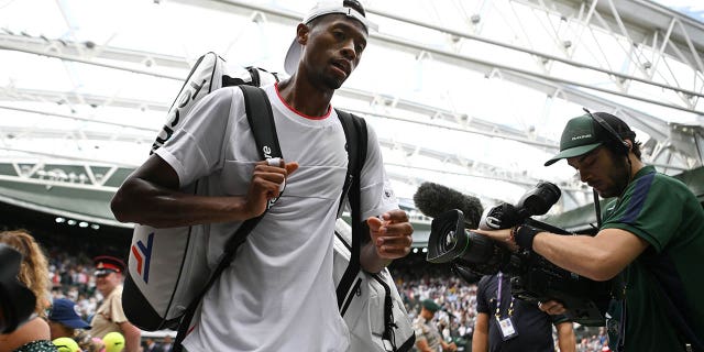 Christopher Eubanks walks off the court after losing a quarterfinal match at Wimbledon