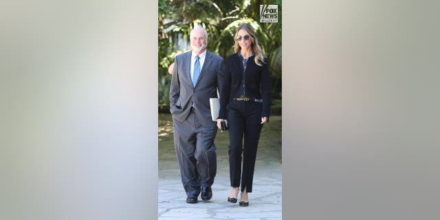 Christine Baumgartner walks in the courtyard of the court with her lawyer