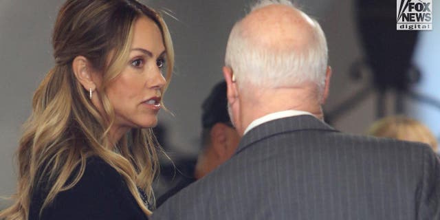 Christine Baumgartner stands in the doorway of the court with her lawyer