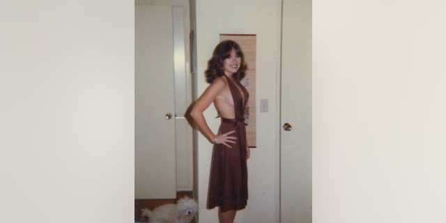 Victoria Hallman wearing a daring purple dress