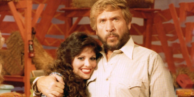 Victoria Hallman being embraced by Buck Owens