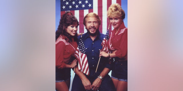 Victoria Hallman in her "Hee Haw" costume with Buck Owens and a co-star