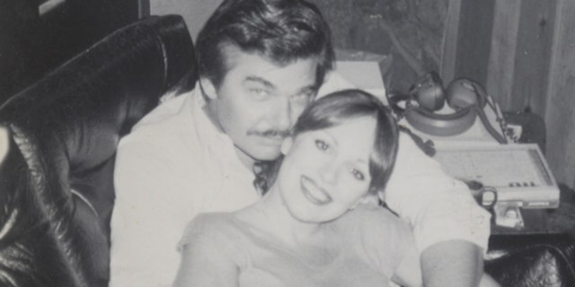Victoria Hallman being embraced by her husband