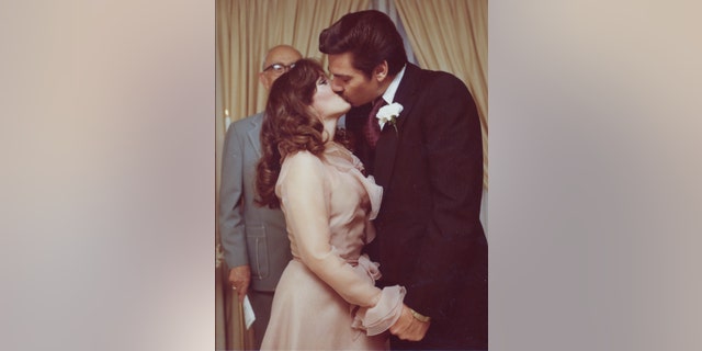Victoria Hallman kissing her husband on her wedding day