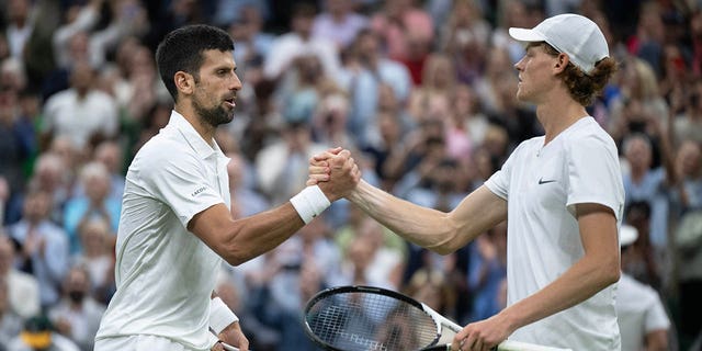 Novak Djokovic shakes hands with Jannik Sinner