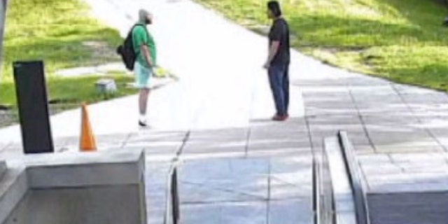 Maxwell Emerson, left, talking to Jaime Macedo (left) outside Metro station