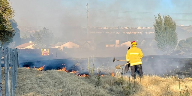 Firefighters put out flames near residential neighborhood