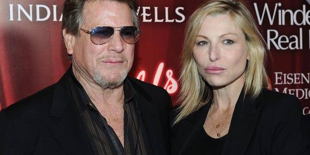 Ryan O'Neal wearing sunglasses posing with Tatum O'Neal