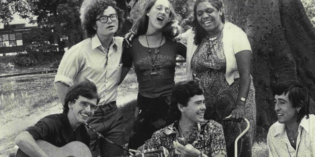 A photo of Children of God members singing and playing instruments
