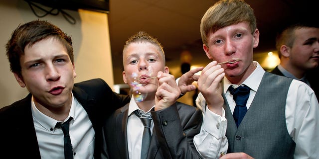 Teenagers blow bubbles during the school prom on July 1, 2011 in Newcastle, United Kingdom.