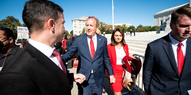 Texas Attorney General Ken Paxton and his wife Angela are pictured outside the Supreme Court on Nov. 1, 2021.