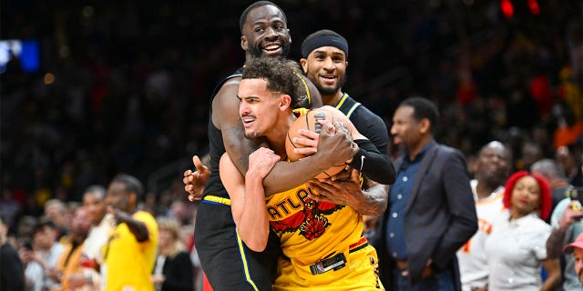 Draymond Green fouls Trae Young