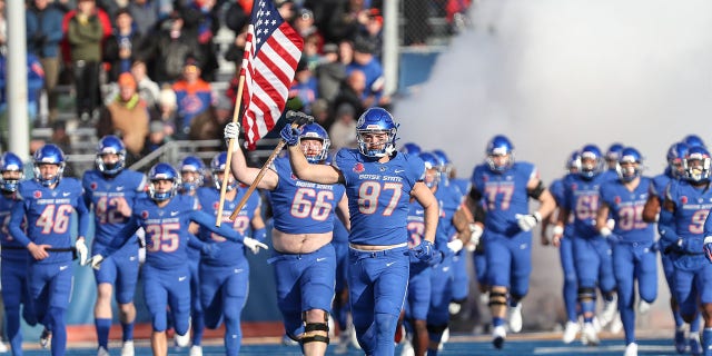 The Broncos run onto the field