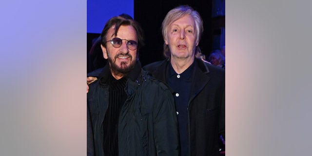 Ringo Star and Paul McCartney stand next to each other in 2022