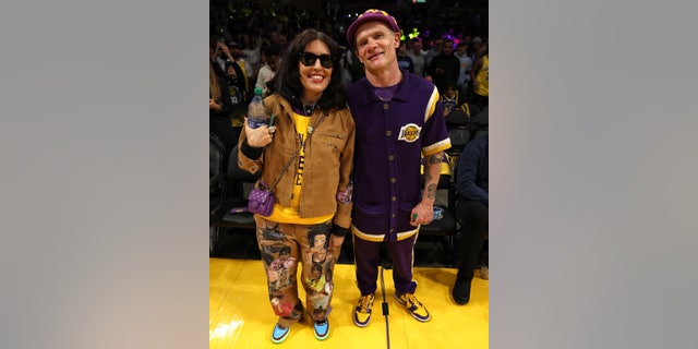 Flea with wife Melody Ehsani at a Lakers Game