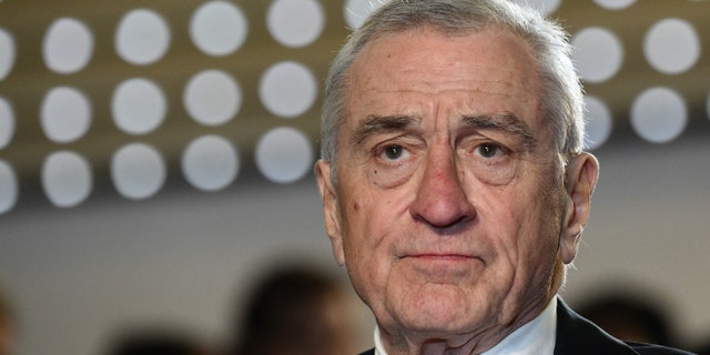 Robert De Niro looks up in a suit