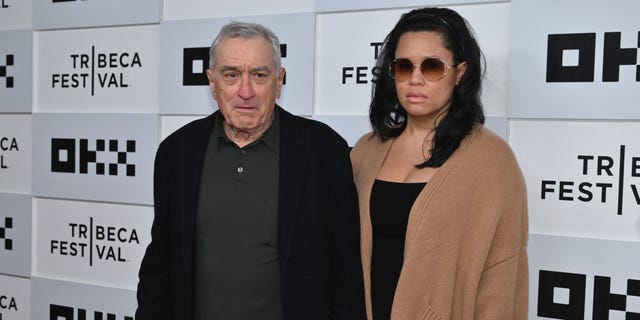 Robert De Niro holds Tiffany Chens hand on the carpet