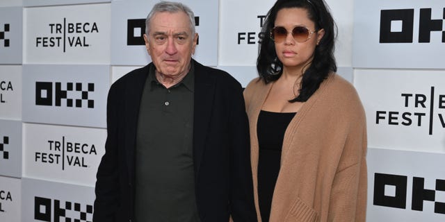 Robert De Niro holds Tiffany Chens hand on the carpet