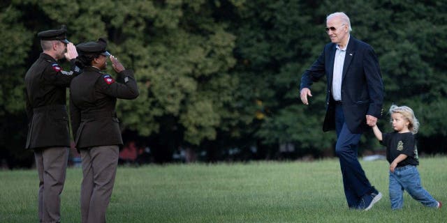 Joe Biden walks with his grandson Beau Biden after arriving on Marine One