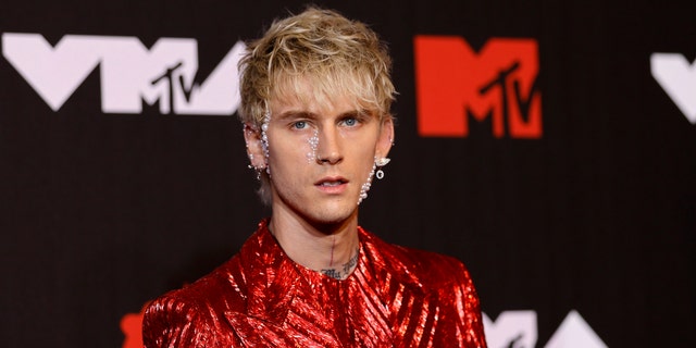 Machine Gun Kelly in a metallic red outfit in New York