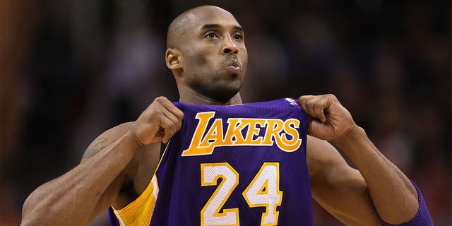 Kobe Bryant adjust his jersey against the Suns