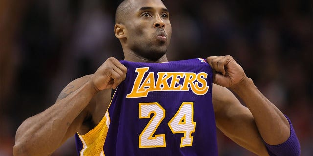 Kobe Bryant adjust his jersey against the Suns