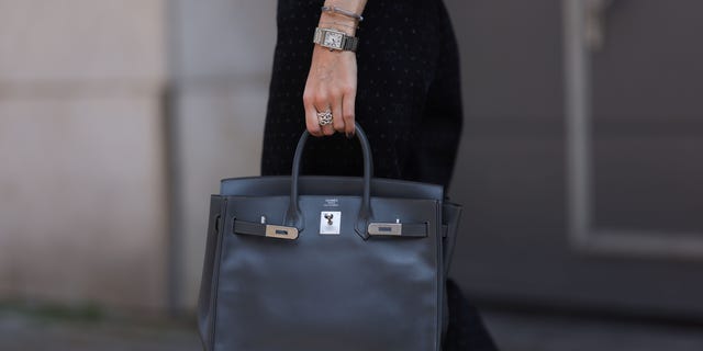 Black Birkin bag held by a woman in Germany