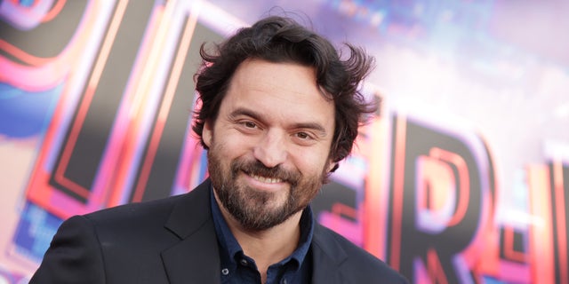 Jake Johnson with a beard on the Spider-Verse red carpet