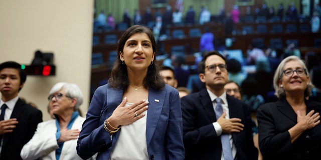 Lina Khan with her hand on her heart while saying the pledge of allegiance before the House Judiciary Committee