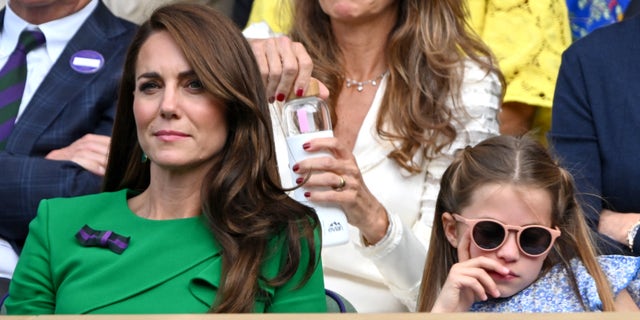 Kate Middleton and Princess Charlotte watch Wimbledon in the stands.