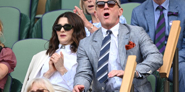 Rachel Weisz and Daniel Craig wear sunglasses in the stands at Wimbledon.