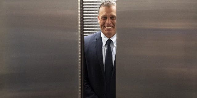 Devon Archer gets into an elevator